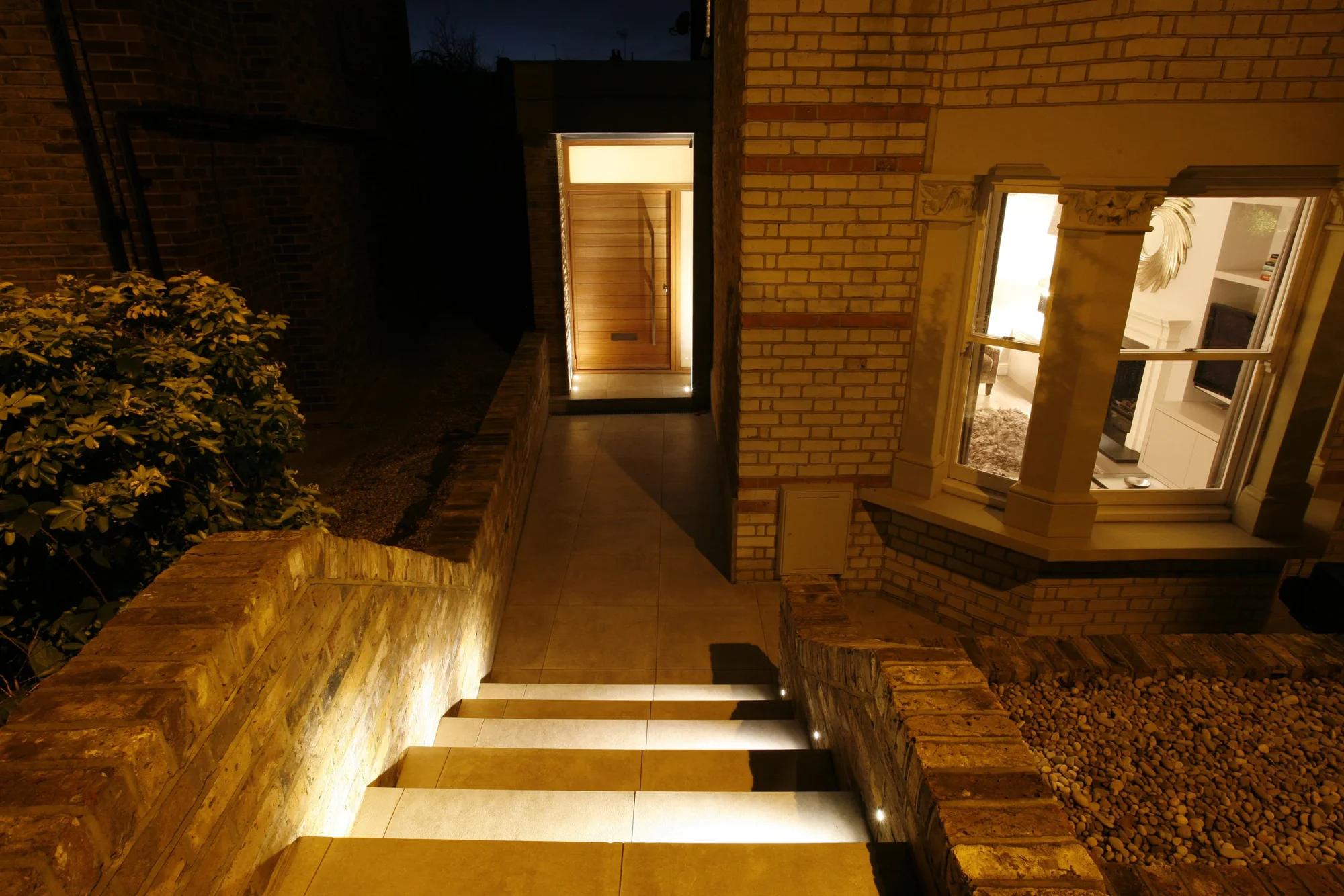 A garden path and steps illuminated after dark